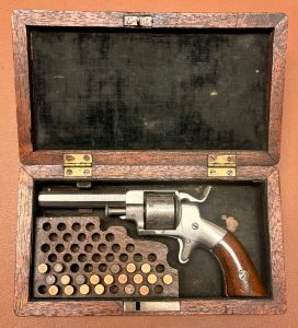 Allen & Wheelock 22RF Side-Hammer Revolver - Intermediate Fifth Model - Left side view - In wooden case with cartridges